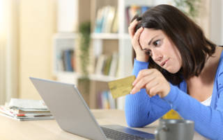 Worried woman buying online at home
