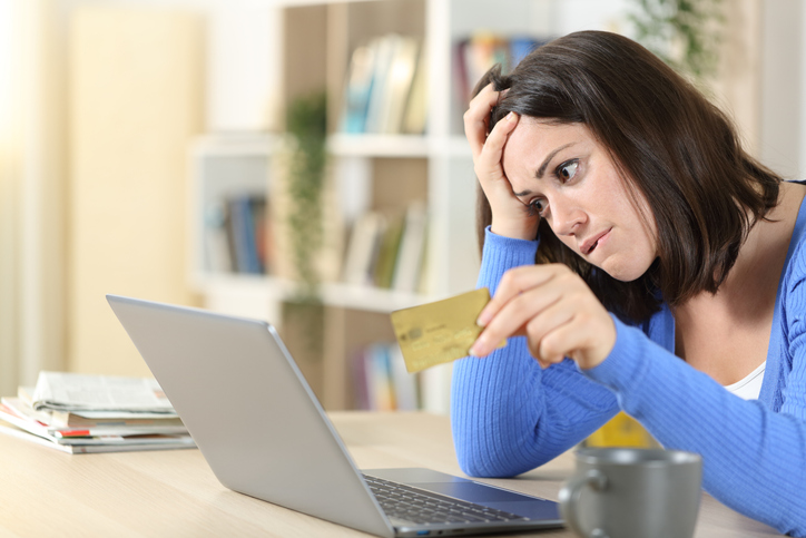 Worried woman buying online at home